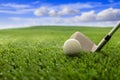 Golfball and stick on green grass golf course, blue cloudy sky background Royalty Free Stock Photo