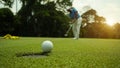 Golfer action to win after long putting golf ball in to the hole Royalty Free Stock Photo