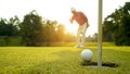 Golfer action to win after long putting golf ball in to the hole Royalty Free Stock Photo