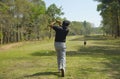 Golfer addressing the ball as he is about to tee off with a driver on a short four par Royalty Free Stock Photo