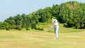 Golfer asian man swing and hitting golf ball practice at golf driving range Royalty Free Stock Photo