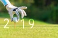 Golfer asian woman putting golf ball for Happy New Year 2019 on the green golf, copy space. Royalty Free Stock Photo