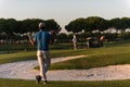 Golfer from back at course looking to hole in distance Royalty Free Stock Photo