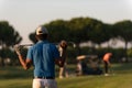 Golfer from back at course looking to hole in distance Royalty Free Stock Photo