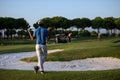 Golfer from back at course looking to hole in distance Royalty Free Stock Photo