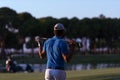 Golfer from back at course looking to hole in distance Royalty Free Stock Photo