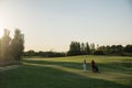 Golfer and Caddie playing golf.