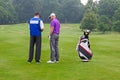 Golfer and caddy reading a course guide