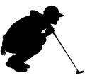 Golfer crouching on the golf course analyzing, planning the golf tee shot, golf swing with a golf club in hand. Golfer in a squat Royalty Free Stock Photo