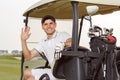 Golfer in golfcart with his clubs Royalty Free Stock Photo