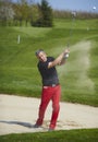 Golfer hitting a ball in the bunker