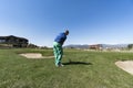 Golfer Hitting Ball with Club