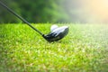 Golfer hitting golf ball on tee off zone in golf course Royalty Free Stock Photo