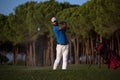 Golfer hitting a sand bunker shot on sunset Royalty Free Stock Photo