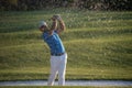 Golfer hitting a sand bunker shot on sunset Royalty Free Stock Photo