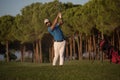 Golfer hitting a sand bunker shot on sunset Royalty Free Stock Photo