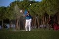 Golfer hitting a sand bunker shot on sunset Royalty Free Stock Photo