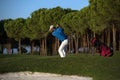 Golfer hitting a sand bunker shot on sunset Royalty Free Stock Photo