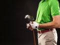 Golfer holding golf ball and a drive on black background Royalty Free Stock Photo