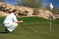 Golfer Lining up a Putt Royalty Free Stock Photo