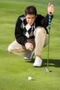 Golfer lining up putt Royalty Free Stock Photo