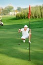 Golfer lining up a putt.