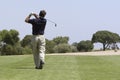 Golfer making fairway shot Royalty Free Stock Photo