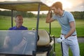 Golfer near golf cart Royalty Free Stock Photo