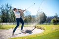 Golfer playing a chip shot onto the green Royalty Free Stock Photo