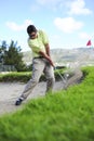 Golfer playing out of a sand trap Royalty Free Stock Photo