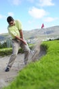 Golfer playing out of a sand trap Royalty Free Stock Photo