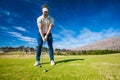 Golfer playing a shot on the fairway Royalty Free Stock Photo