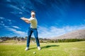 Golfer playing a shot on the fairway Royalty Free Stock Photo