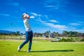 Golfer playing a shot on the fairway Royalty Free Stock Photo