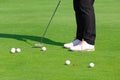 Golfer practice putting golf ball on the green golf, evening time Royalty Free Stock Photo