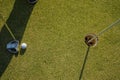 Golfer practice training putting golf ball on the green, lens flare on sun set evening time Royalty Free Stock Photo