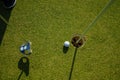 Golfer practice training putting golf ball on the green, lens flare on sun set evening time Royalty Free Stock Photo