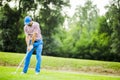 Golfer practicing and concentrating before and after shot Royalty Free Stock Photo