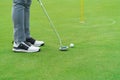 Golfer preparing for a putt Golf ball on the green during golfcourse