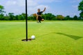 Golfer putt golf ball into hole on the green at golf course