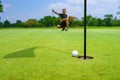 Golfer putt golf ball into hole on the green at golf course