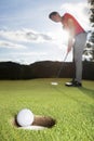 Golfer putting ball into cup. Royalty Free Stock Photo