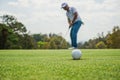 Golfer putting ball on the green golf, lens flare on sun set evening time. Golfer action to win after long putting golf ball in to Royalty Free Stock Photo