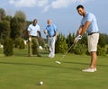 Golfer putting ball on green Royalty Free Stock Photo