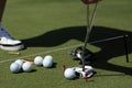 A golfer with putting and balls near a hall Royalty Free Stock Photo