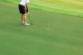 Golfer putting golf ball on the green golf Royalty Free Stock Photo