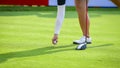 Golfer putting golf ball on green grass for check fairway to hole Royalty Free Stock Photo