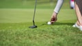 Golfer putting golf ball on green grass for check fairway to hole Royalty Free Stock Photo