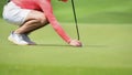 Golfer putting golf ball on green grass for check fairway to hole Royalty Free Stock Photo