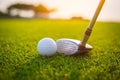 Golfer is putting golf ball on green grass at golf course for training to hole with blur background a